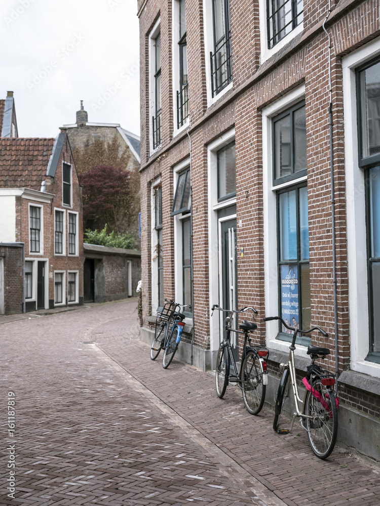 bicycles are parked against house in the centre of old capital Leeuwarden of province of friesland in the netherlands