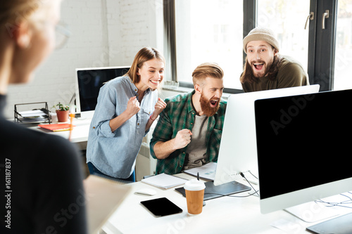 Smiling colleagues in office talking