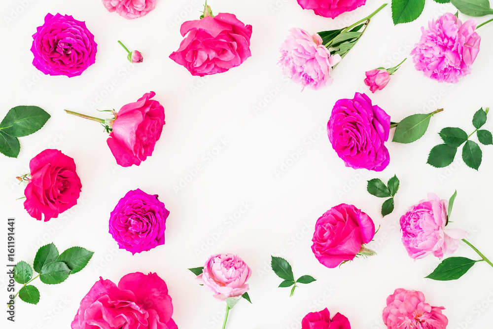 Floral frame of beautiful ranunculus flowers, roses and leaves on white background. Flat lay, top view. Floral lifestyle composition.