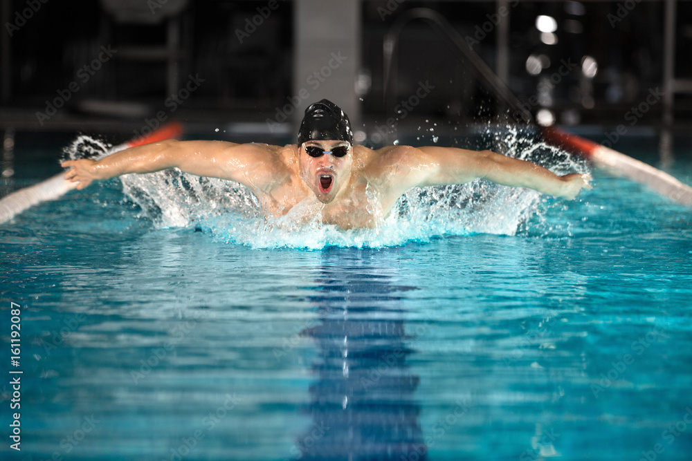 Young male swimmer swimming the butterfly stroke