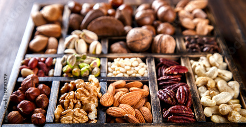 Nuts Mixed in a Wooden Vintage Box.Assortment, Walnuts,Pecan,Peanuts,Almonds,Hazelnuts,Macadamia,Cashews,Pistachios.Concept of Healthy Eating.Vegetarian.selective focus.