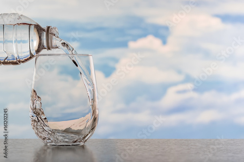 Drinking water poured into the glass. © Guitafotostudio