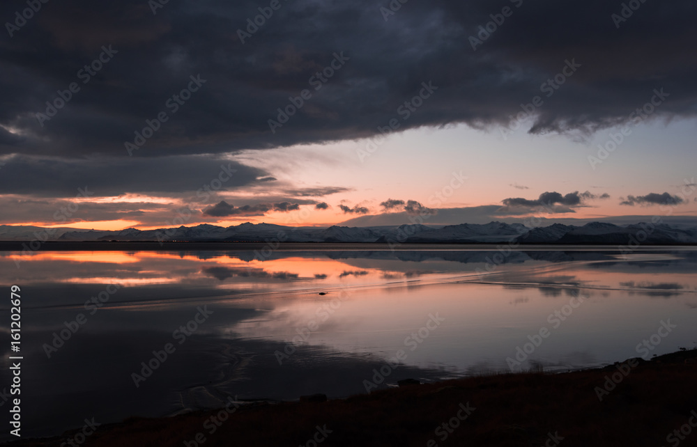 Beautiful sunset and mountains. reflecting in the lake Beautiful sunset and mountains. reflecting in the lake