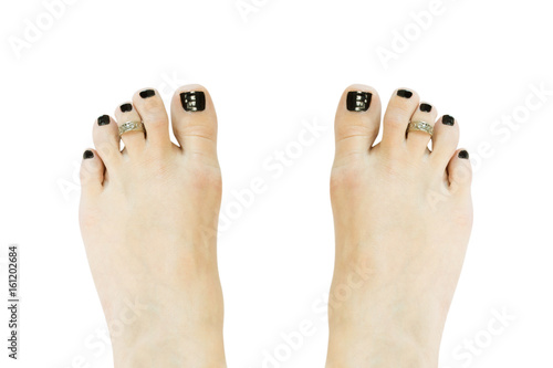 Barefoot woman with black painted toes and toe ring isolated on white background. Concept of wellness and body care. photo