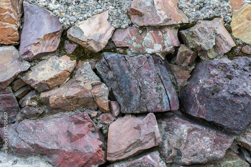 Stone wall. multicolor stone texture. Pink granite and colored marble.