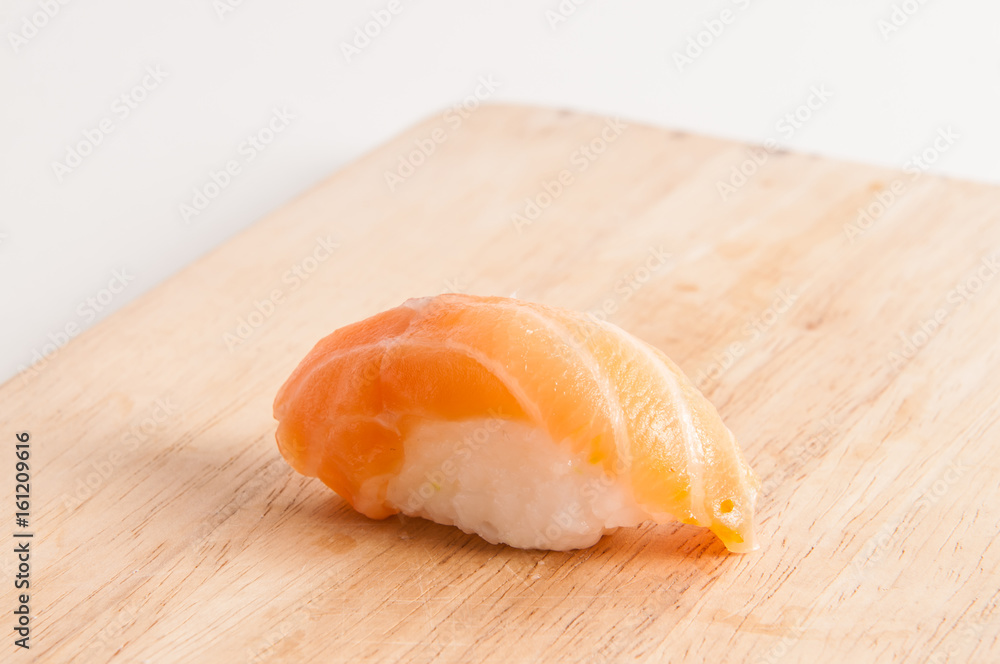 Sushi on wooden board.