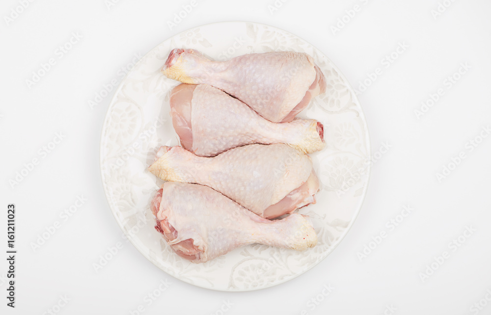 Top view of pile of raw chicken thighs isolated on dish. Top view of pile of raw chicken thighs isolated on dish.