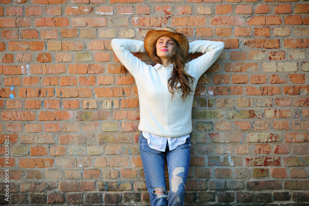 Resting woman standing near brick wall, closed eyes, enjoying, street lifestyle, outdoot, copy space,style Resting woman standing near brick wall, closed eyes, enjoying, street lifestyle, outdoot, copy space,style