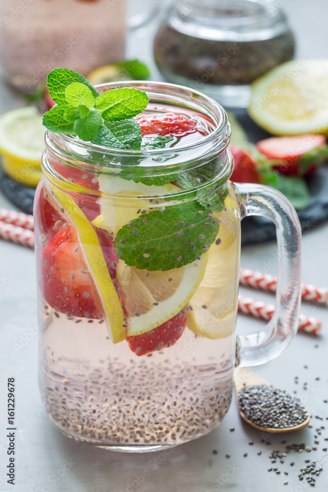 Healthy detox chia seed drink with strawberry, lemon and mint in jar, vertical Healthy detox chia seed drink with strawberry, lemon and mint in jar, vertical