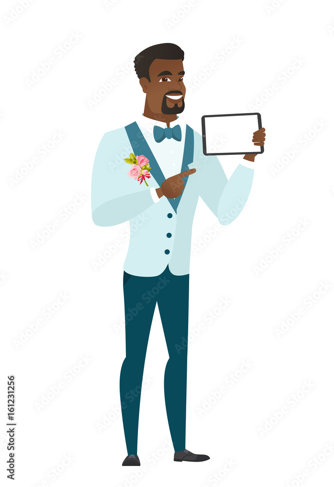 Smiling groom holding tablet computer.