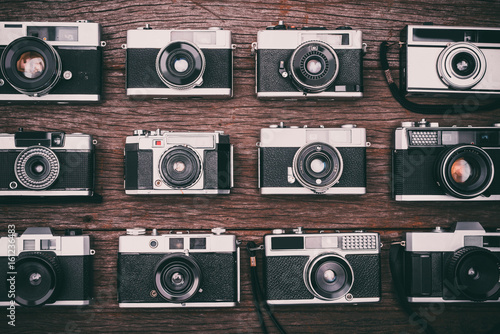 Retro film photo camera on wooden background