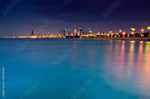 Streetlights reflected in urban harbor © Image Source