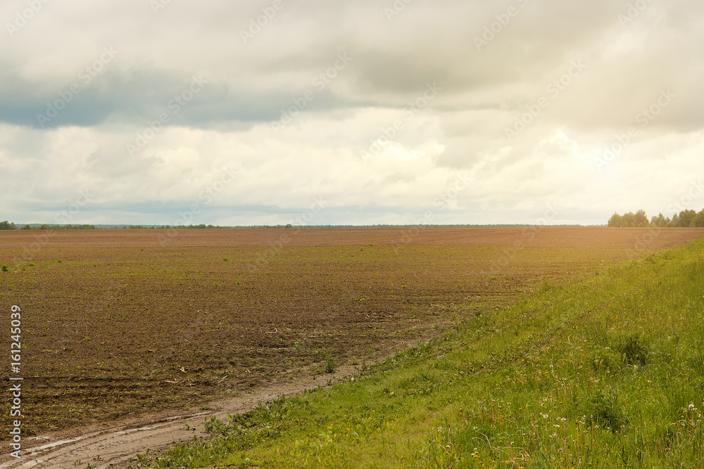 village plowed field on a cloudy day