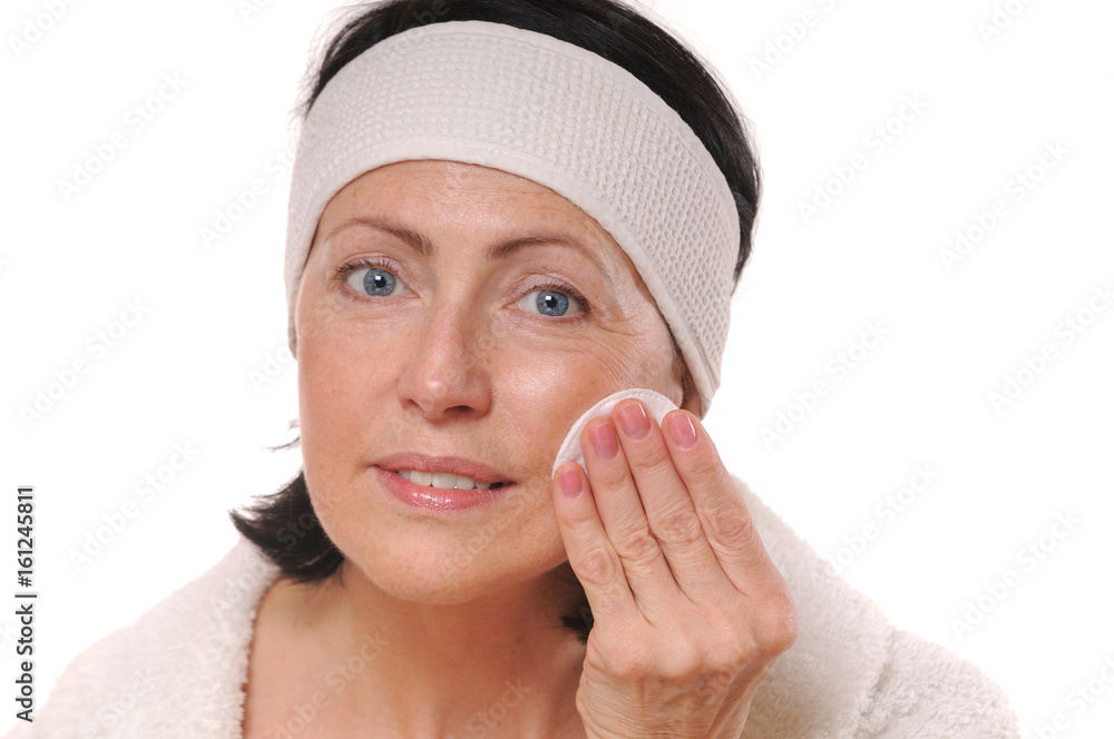 portrait of pretty senior woman taking off makeup portrait of pretty senior woman taking off makeup
