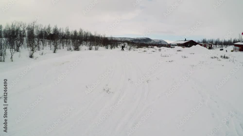 Man drives snowmobile in winter landscape Man drives snowmobile in winter landscape