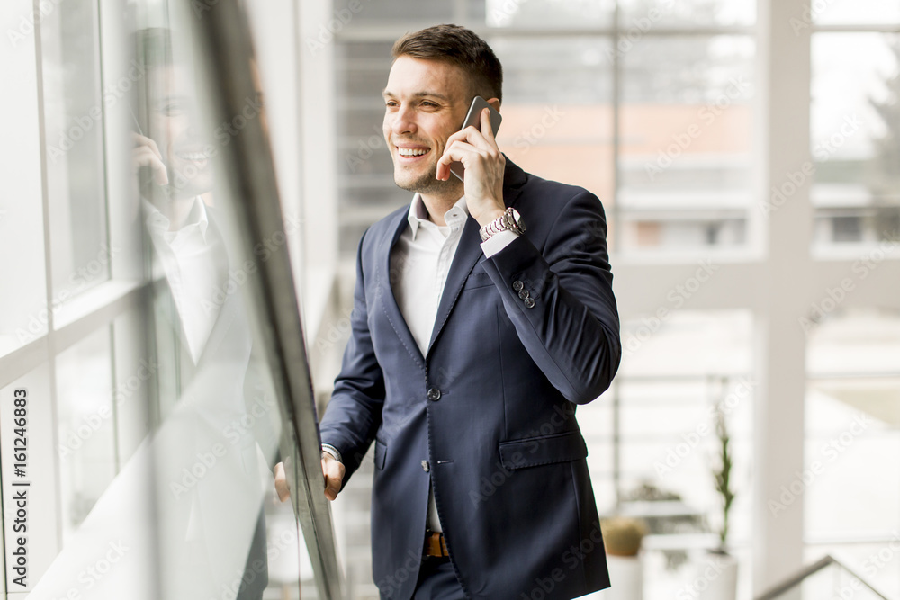 Handsome businessman in classic suit talking on mobile phone Handsome businessman in classic suit talking on mobile phone