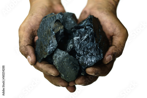 Selective focus of coal in worker's hands isolated on the white background, energy concept