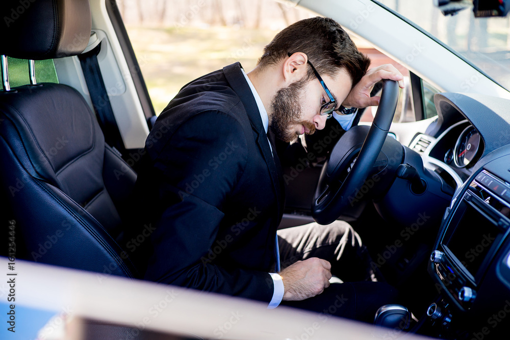 Obraz premium Tired man in a car