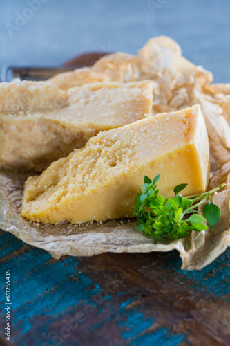 Traditional Italian hard cheese Parmesan and Grana Padano with grater and fresh basil