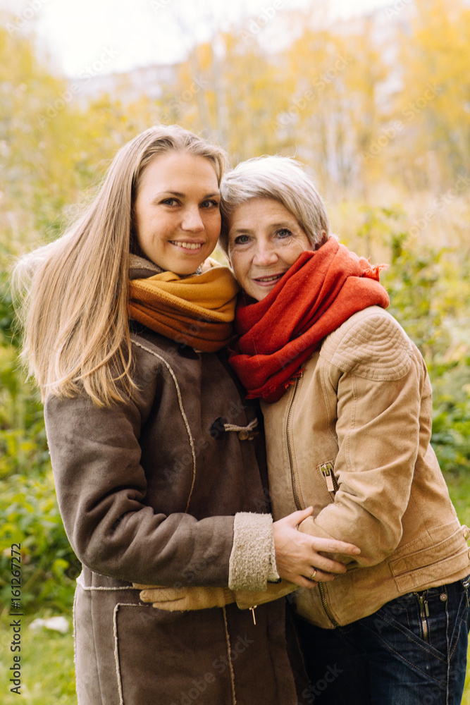 Fototapeta premium Happy mother and daughter portrait. Portrait of beautiful mature mother and her daughter . 