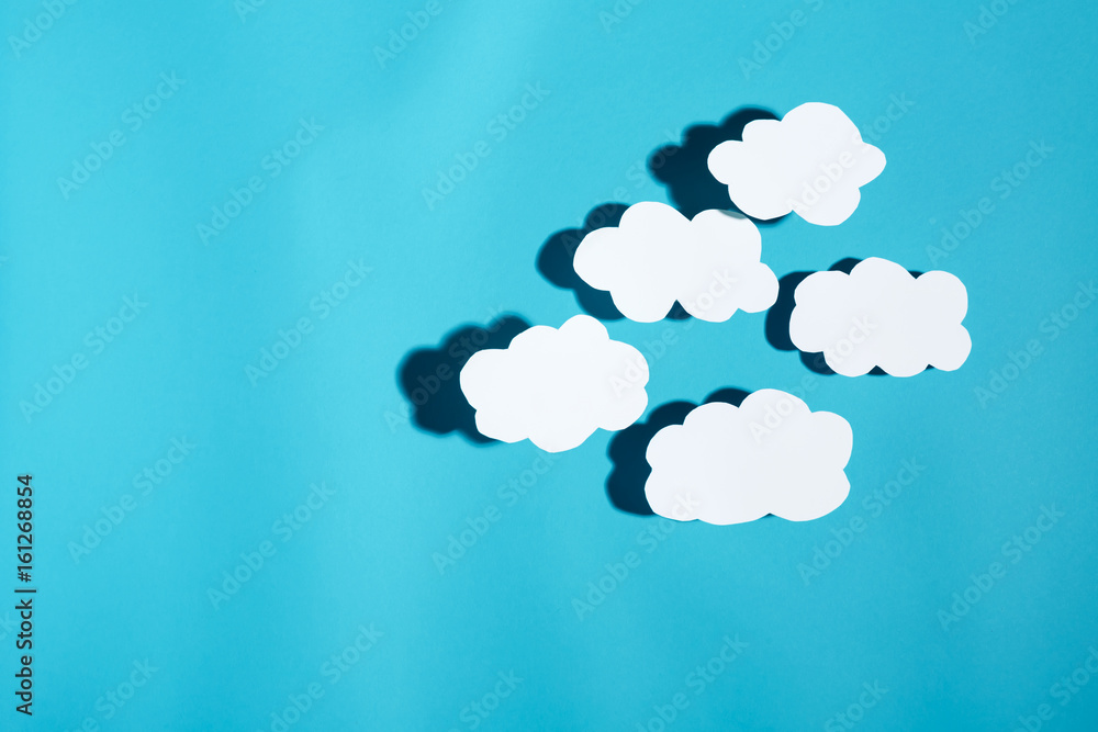 Paper cloud with hard shadow on a blue background Paper cloud with hard shadow on a blue background