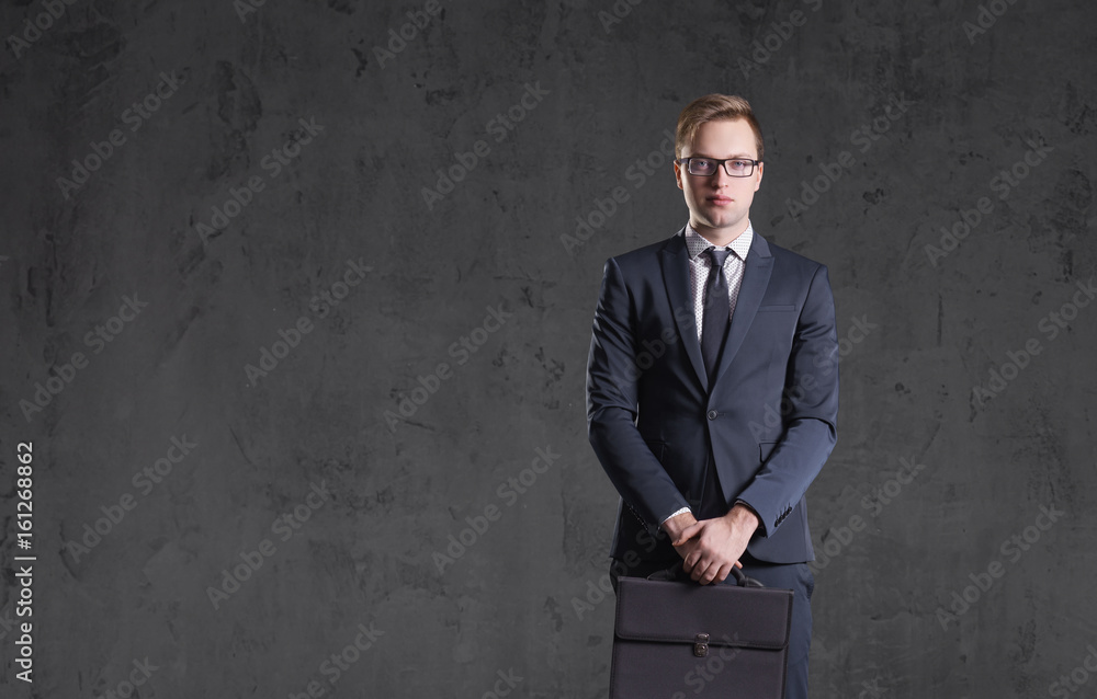 Businessman standing over dark wall background. Business, career job concept. Businessman standing over dark wall background. Business, career job concept.