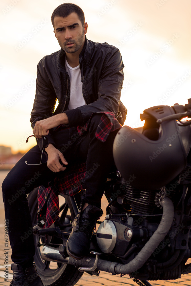 Handsome rider guy with beard and mustache in black leather biker ...