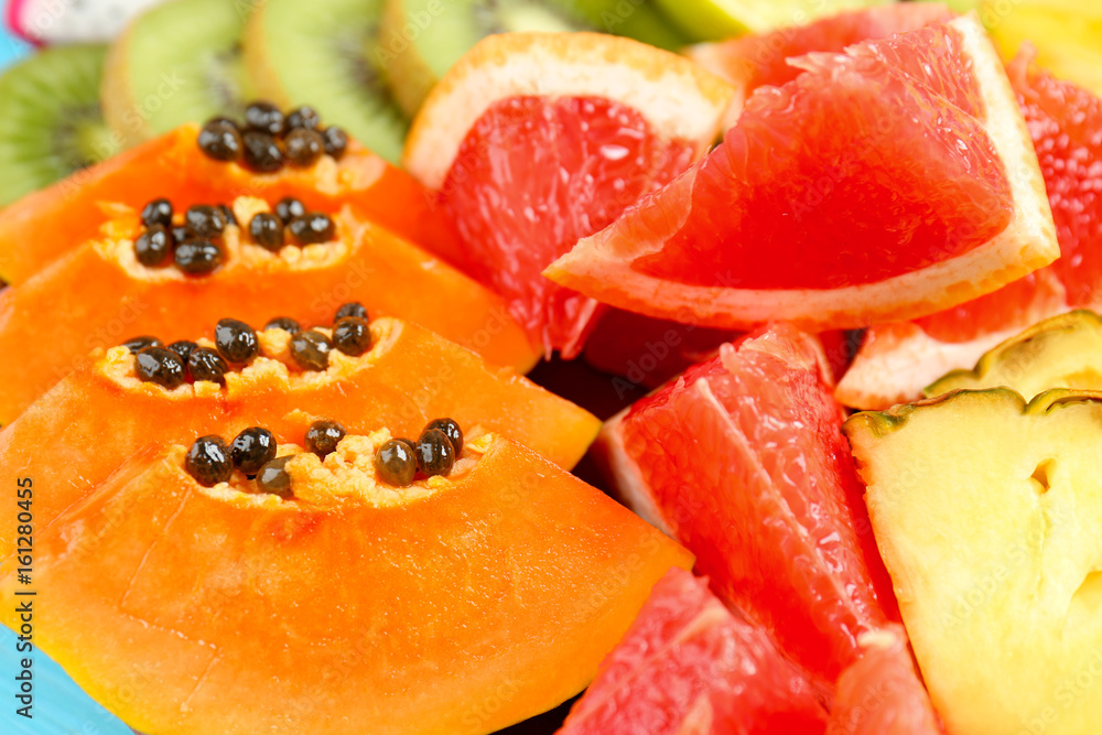 Juicy exotic fruits on blue background Juicy exotic fruits on blue background