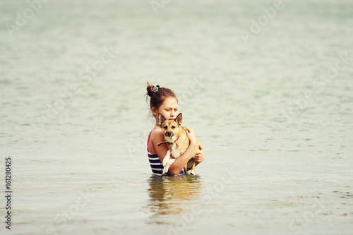Child and dog in the sea