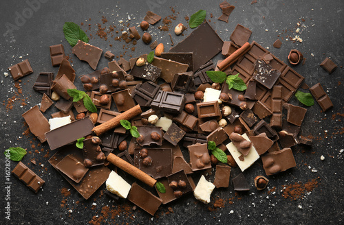 Heap of broken chocolate pieces on table