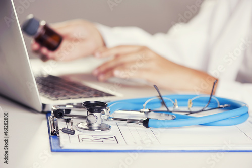 Close up of female doctor working on a laptop