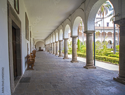 Corridors, columns and benches of the interior patios of the San Francisco church, in Quito, Ecuador.