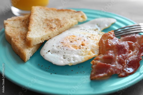 Delicious breakfast with over hard egg, closeup