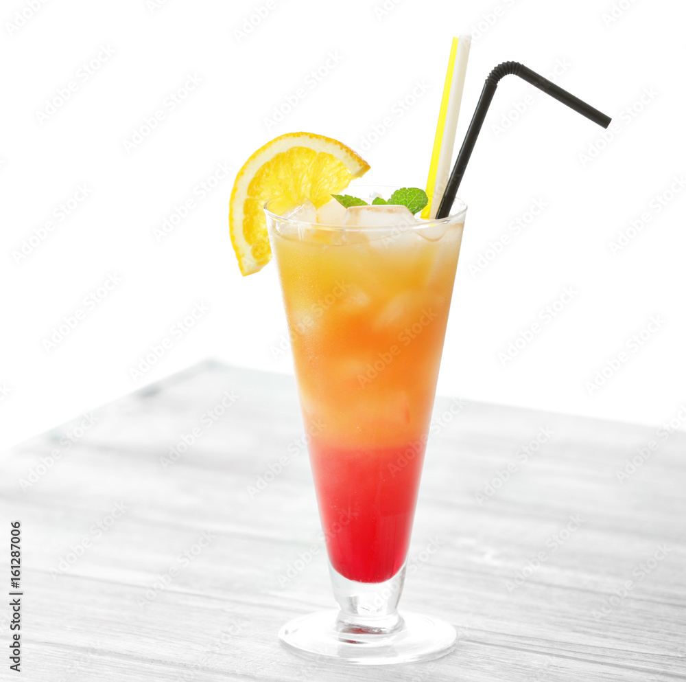 Glass of Tequila Sunrise cocktail on wooden table Glass of Tequila Sunrise cocktail on wooden table