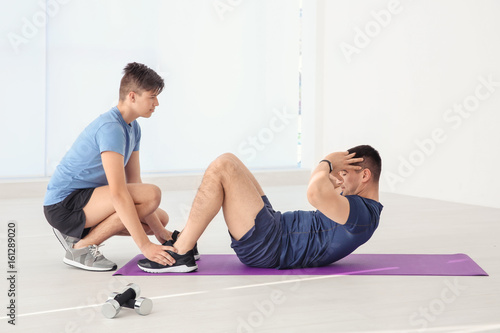Dad and son training in gym