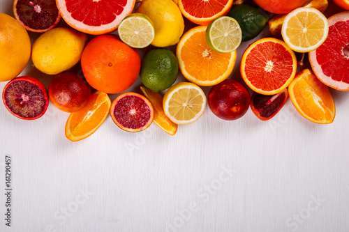 Different Citrus Fruit on a White Background .Mixed Colorful Tropical Background.Food or Healthy diet concept.Vegetarian.Copy space for Text. selective focus.