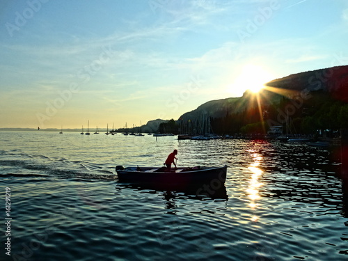 Boat in Garda Lake at sunset