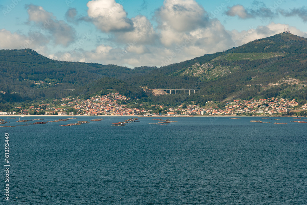 View from the sea of Vigo, Spain with mussel farms, sailboats and copy space
