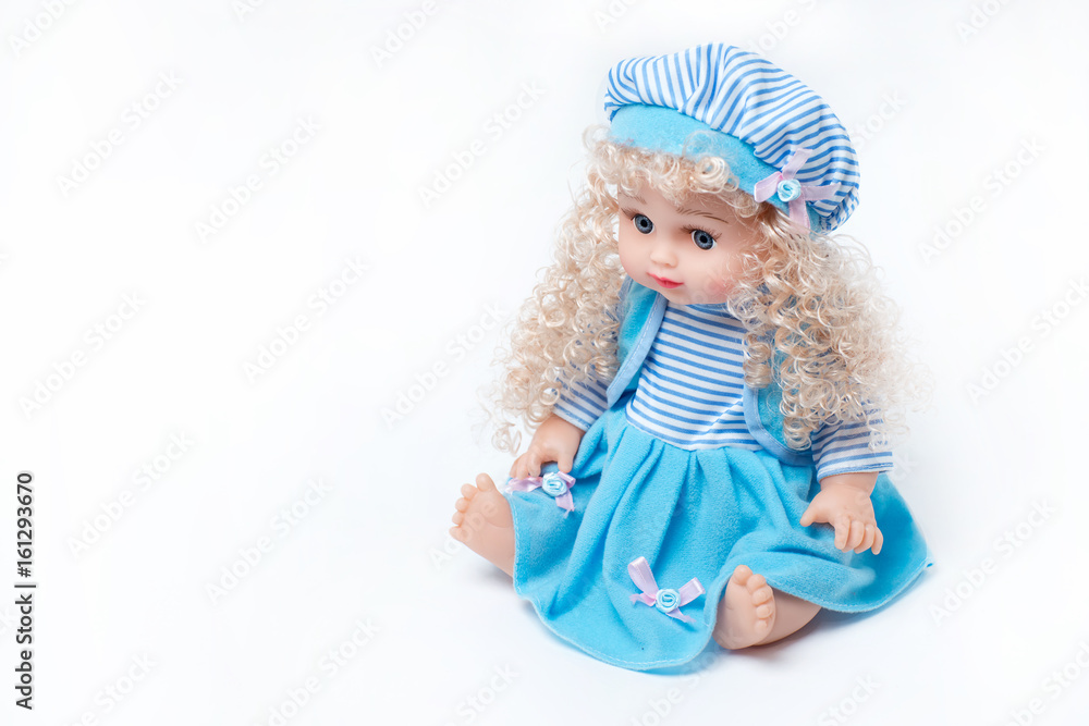 Beautiful baby doll with blond hair in blue dress isolated on white background Beautiful baby doll with blond hair in blue dress isolated on white background