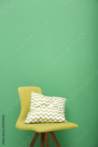 Cozy chair on green background