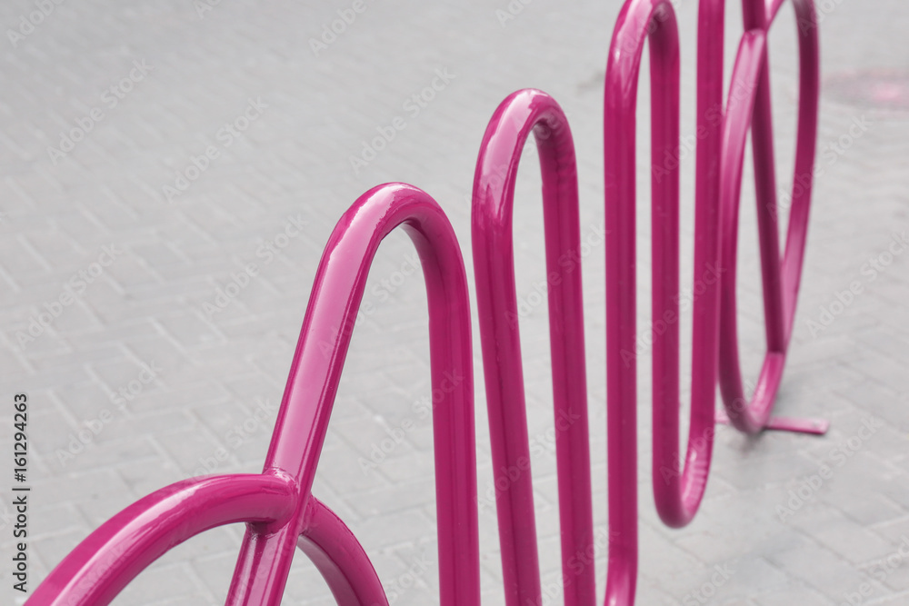 Empty colorful bicycle rack on sidewalk