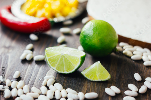 Pieces of green lime on wooden board