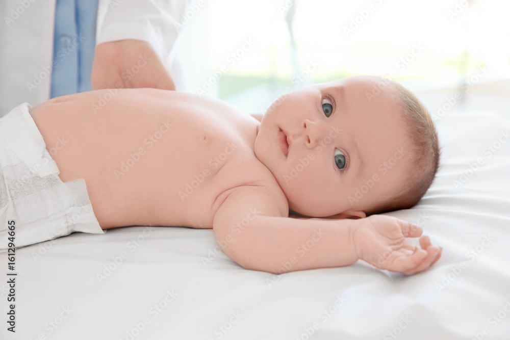 Doctor examining little baby in clinic. Baby health concept Doctor examining little baby in clinic. Baby health concept
