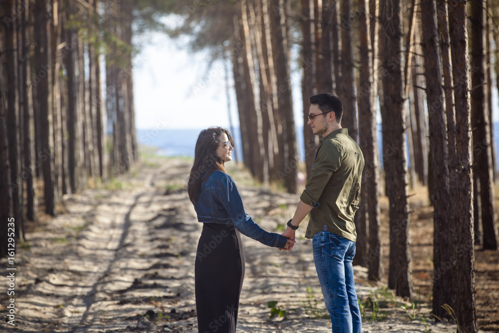 Happy couple walking in the forest. Love story Happy couple walking in the forest. Love story