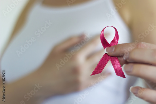 Woman hold pink ribbon for breast cancer awareness photo