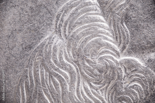 Engraved metal on a coin, microscopic background texture.
