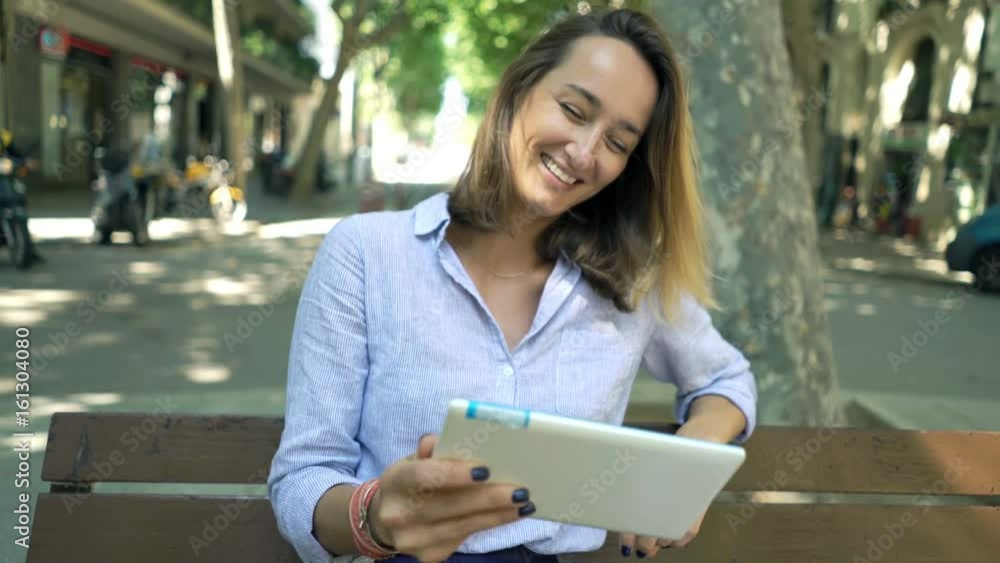 Happy businesswoman watching movie on tablet sitting on bench in city
Happy businesswoman watching movie on tablet sitting on bench in city