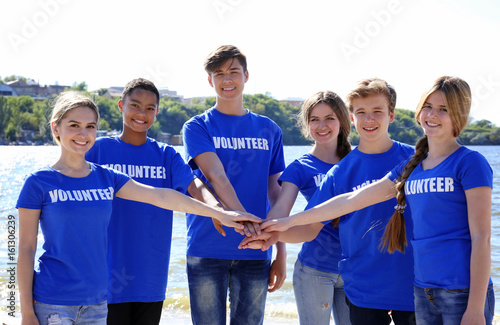 Young people putting hands ...