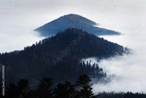 Beautiful view of the sunset in the mountains and valleys with fog. French Alsace, Vosges mountains