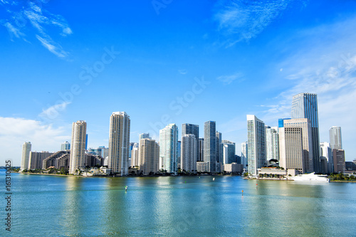 Miami skyscrapers with blue cloudy sky, boat sail, Aerial view © be free